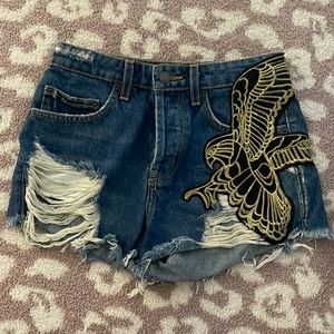 NWOT Carmar denim distressed shorts with black and gold bird detail